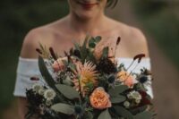 12 a bold fall wedding with peachy roses and dahlias, deep purple blooms, greenery, thistles and berries is a lovely solution