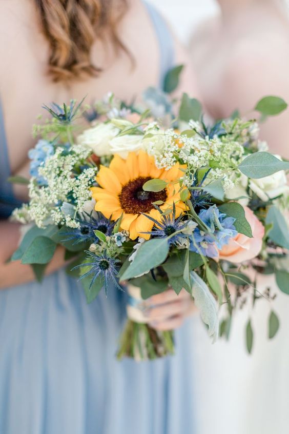 a bold wedding bouquet of thistles, white roses, sunflowers, greenery and some white fillers is a cool idea for a summer wedding