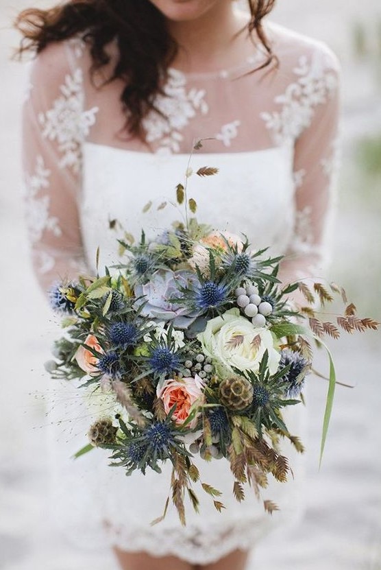 a bright and cheerful wedding bouquet with white and peachy blooms, thistles, berries and seed pods plus grasses