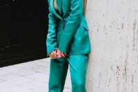 14 an emerald pantsuit with a long blazer, pants, pink shoes and statement earrings is a catchy look to rock