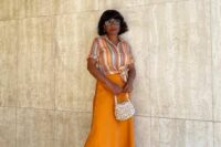 15 a bold and casual summer wedding guest look with a striped shirt, an orange slip midi skirt, chic shoes and a woven bag