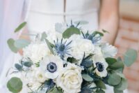 20 a chic and classic wedding bouquet of white roses and anemones, thistles and greenery