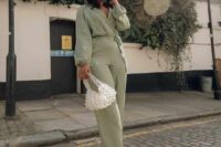 22 a green jumpsuit, white strappy shoes, a beaded bag for a spring or summer wedding