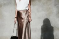 22 a white top with statement shoulders, an elegant taupe midi slip skirt, silver shoes and a black bag