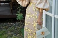 24 a beautiful off the shoulder midi fitting dress with a plain bodice, puff sleeves and a floral print skirt, lemon yellow shoes and statement earrings