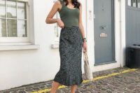 25 a casual summer wedding guest look with a green crop top, a printed midi skirt, neutral shoes and a woven bag
