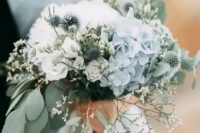 27 a delicate wedding bouquet of white roses and blue hydrangeas, eucalyptus, allium and some waxflower is a dreamy solution for a spring bride