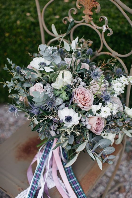 a delicate wedding bouquet with ligth pink roses, white anemones, thistles, berries and eucalyptus plus pink and plaid ribbons