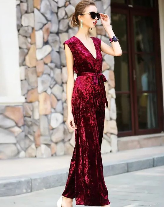 a red velvet belted jumpsuit with no sleeves and a sash is a gorgeous idea for a fall or winter wedding