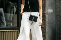 31 a black top, white wideleg pants, black heels and a mini bag for a chic monochromatic wedding guest look