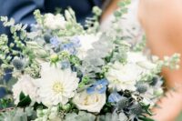 32 a fantastic wedding bouquet of white roses and dahlias, blue blooms and thistles, foliage and greenery is a lovely idea