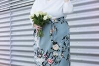 34 a tender spring wedding guest of a white top with long sleeves and a powder blue floral midi skirt, off-white shoes