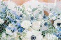 37 a jaw-dropping and lush wedding bouquet of white peony roses and anemones, blue blooms, eucalyptus and thistles is wow