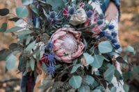 38 a jaw-dropping wedding bouquet with king proteas, thistles, amaranthus and lots of eucalyptus will make a statement