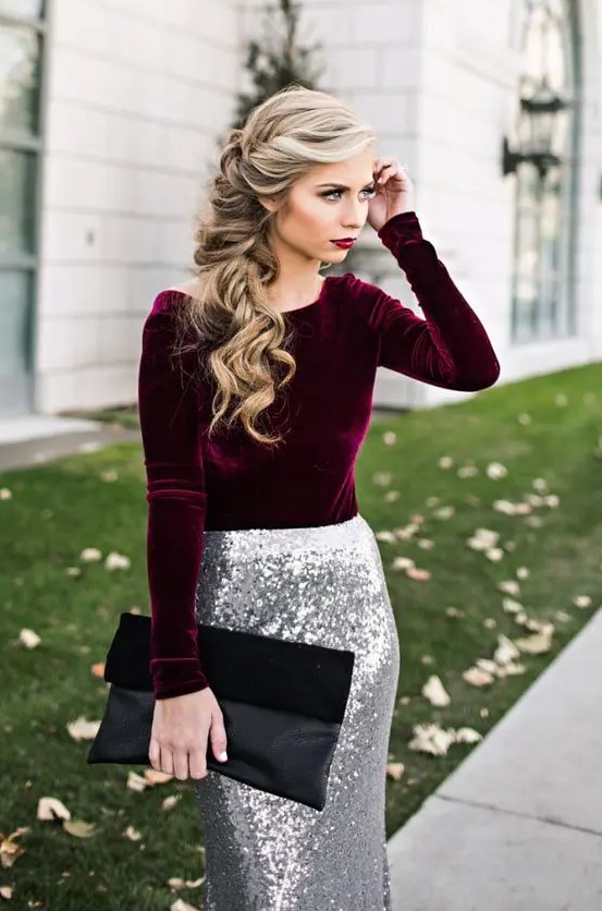 A plum colored velvet long sleeve shirt, a silver sequin maxi skirt, a black suede and leather clutch