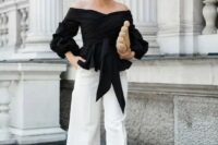 40 a monochromatic look with an off the shoulder black draped blouse, white wideleg pants, black heels and a woven clutch