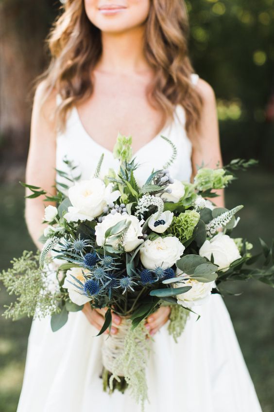 a lovely wedding bouquet with white roses, anemones, astilbe, thistles and greenery is a gorgeous idea for spring and summer