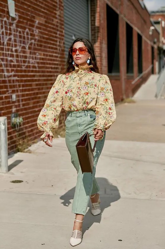 A pretty and elegant vintage inspired wedding guest look with a tan floral blouse with puff sleeves, mint colored pants, white shoes and a brown bag