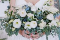 45 a lush and textured wedding bouquet of white blooms, blue fillers, blue thistles, greenery is a cool idea for a spring or summer wedding