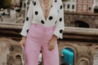 45 a pretty wedding guest outfit with a polka dot blouse and pink pants, a straw hat and strands of pearls plus statement earrings