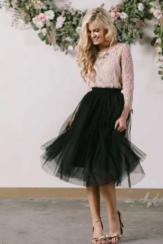 a black tulle skirt, a dusty pink lace top with sleeves, a statement necklace and nude heels
