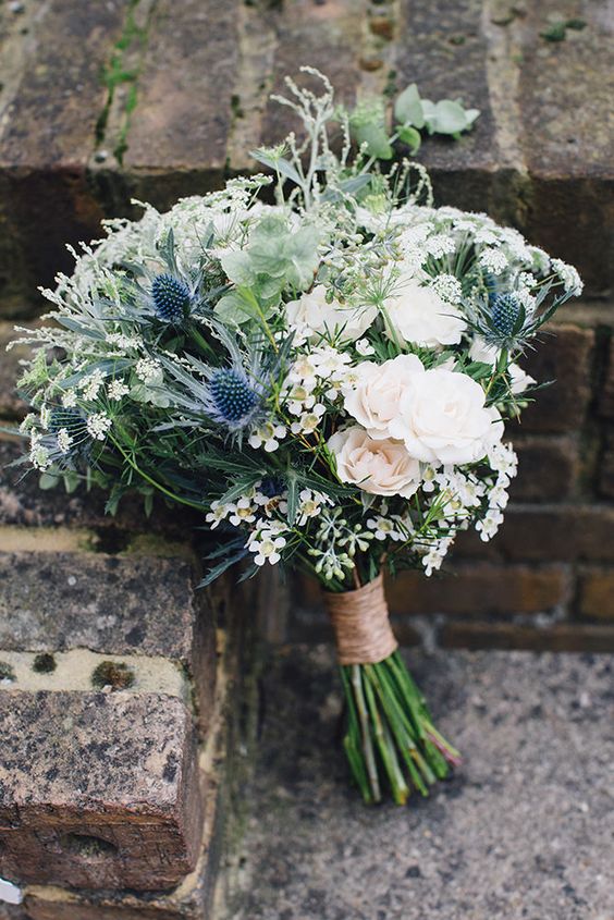 a romantic wedding bouquet of white and blush blooms, thistles, greenery and waxflowers is a lovely idea for a rustic wedding