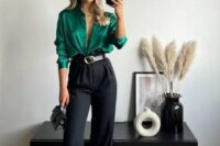 49 an elegant wedding guest look with an emerald shirt, black high waisted pants, a two-tone belt, a tiny black bag