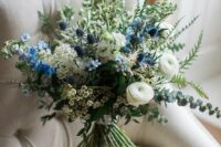 51 a stylish wedding bouquet with white blooms, blue ones, thistles and some greenery looks ethereal and chic