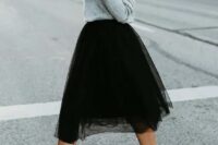 52 a grey off the shoulder sweater, a black tulle skirt, black block heels for a girlish feel