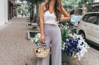 54 slate grey cropped wideleg pants, a white silk top with lace, nude heels and a wicker bag for a casual summer wedding