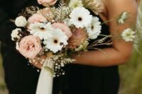 a beautiful and delicate wedding bouquet of white gerberas, blush blooms and some baby’s breath, greenery and ribbon
