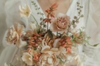 a beautiful carnation wedding bouquet of blush and creamy ones, rust fillers and greenery is a cool idea for a refined modern bride