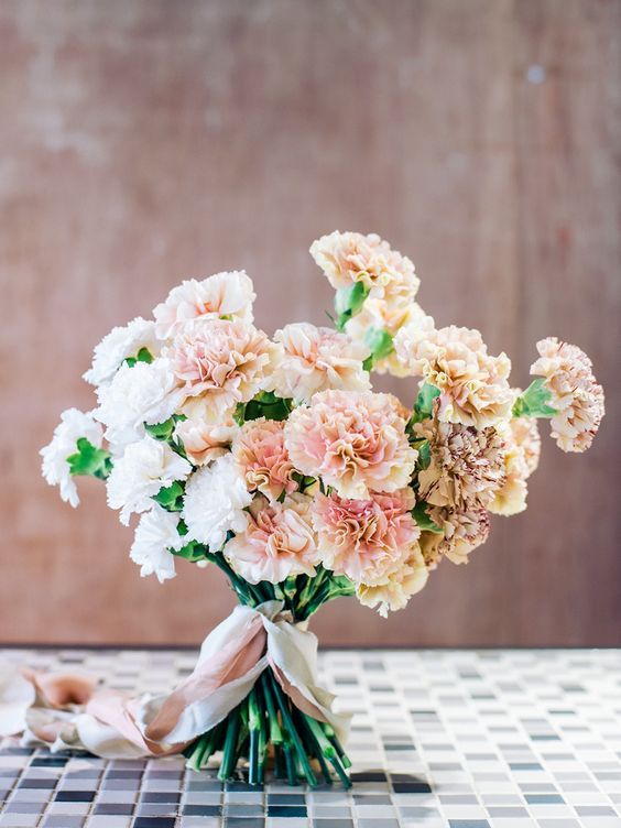 a blush and white carnation wedding bouquet with neutral ribbons is a lovely and classic idea for a wedding, you can make one yourself
