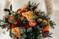 a bold orange wedding bouquet with burgundy and pink blooms, berries, greenery is an amazing idea for the fall