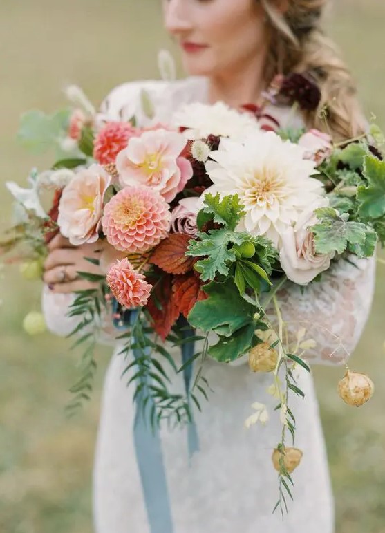 a bold wedding bouquet of white and pink dahlias, blush blooms, seed pods, greenery and blue ribbon is a lovely idea for summer or fall
