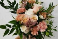 a cappucino-colored wedding bouquet of white and blush roses, blush and coffee-colored carnations, greenery and astilbe is wow