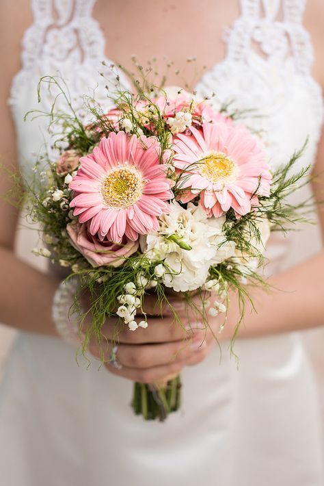 a catchy wedding bouquet of pink roses and gerberas, greenery and lily of the vally is a lovely idea for spring and summer