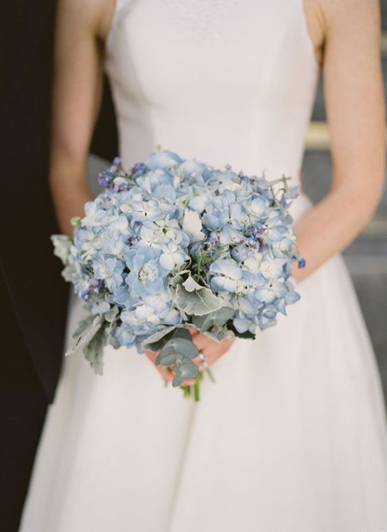 a chic blue wedding bouquet of hydrangeas and other blooms and pale leaves is a lovely idea for a modern bride