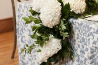 a classic wedding table runner of lush white hydrangeas and greenery is a cool idea for a rustic wedding, it looks stylish