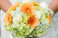 a colorful wedding bouquet of white roses, orange gerberas, green hydrangeas and some fillers is a cool idea