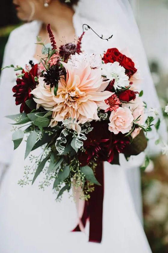 a contrasting fall wedding bouquet with deep purple and burgundy roses and dahlias, blush roses and dahlias, lisianthus and greenery