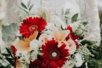 a contrasting wedding bouquet of burgundy gerberas, white and blush roses, lilies, white fillers and greenery