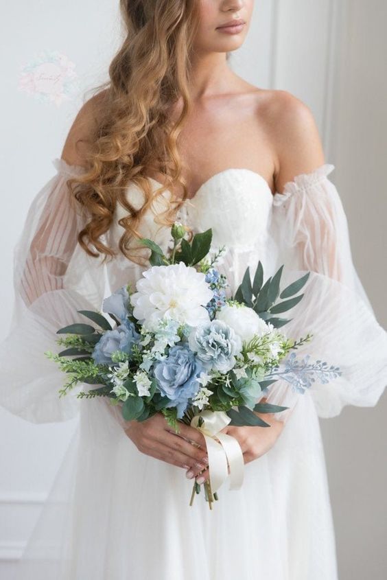 a cool wedding bouquet of white and blue blooms and several types of greeneyr is a very chic and subtle idea