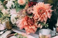 a creative and bright fall wedding centerpiece of dahlias and foliage is a bold and cool idea for your secret garden wedding