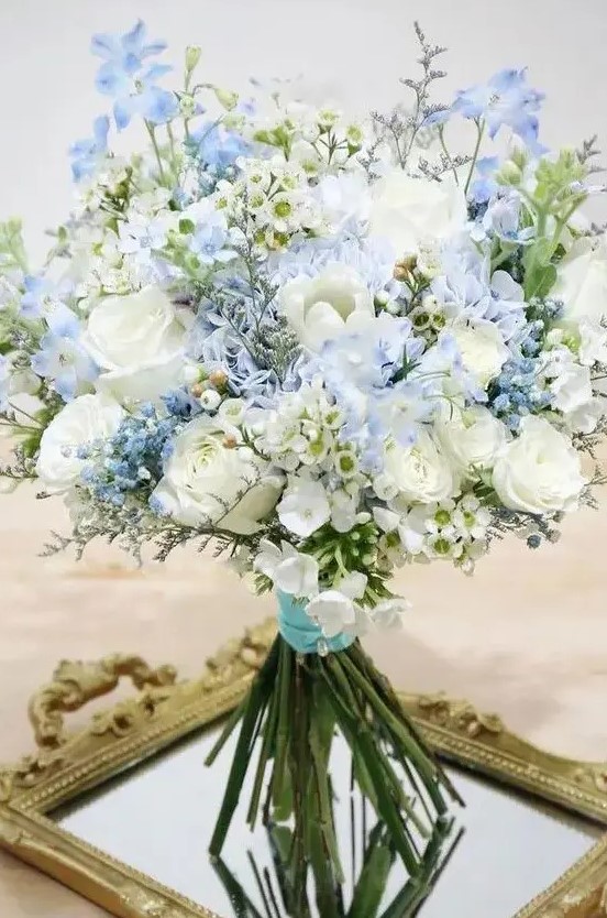 a delicate wedding bouquet of white and blue blooms and nothing else can be composed by you yourself easily