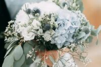 a delicate wedding bouquet of white roses and blue hydrangeas, eucalyptus, allium and some waxflower is a dreamy solution for a spring bride