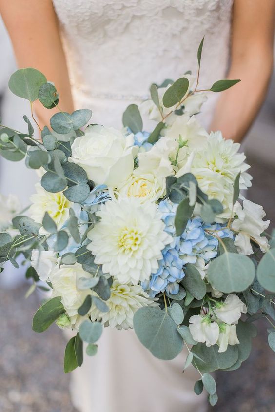 a dimensional wedding bouquet of blue hydrangeas, white roses and dahlias, some eulcayptus is a chic idea