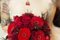 a dramatic red rose and gerbera wedding bouquet with thistles is a stunning idea for a Halloween wedding