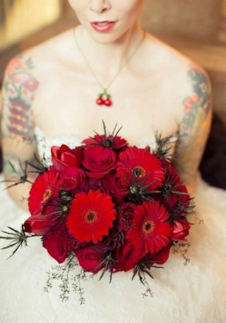 a dramatic red rose and gerbera wedding bouquet with thistles is a stunning idea for a Halloween wedding