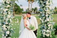a dreamy wedding arch with lots of foliage, white and blue hydrangeas is a lovely idea for a spring or summer wedding